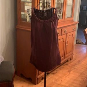 Burgundy sleeveless blouse.